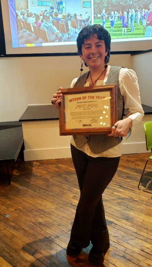 Student holding an award